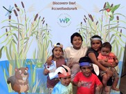 Kids taking picture in front of green screen at Discovery Day