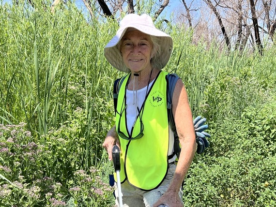 Wetlands Park volunteer posing for photo among lush vegetation