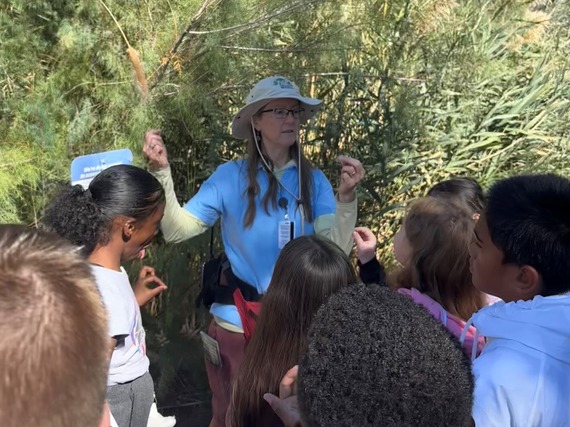 WP volunteer discussing plans with school children
