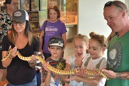 discovery day volunteer holding snake'