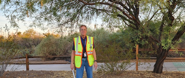 Volunteer Robert Habas standing in front of trees at Wetlands Park
