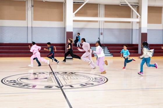 kids running around in a gym