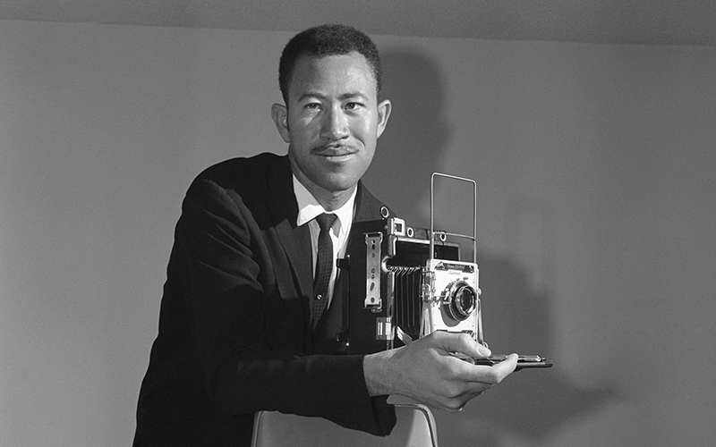 Clinton Wright holding camera photograph 