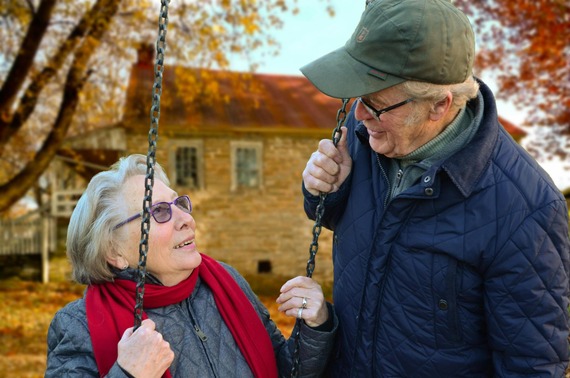 two retirees smile at one another in autumn