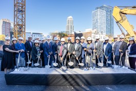 Group shot of groundbreaking with helmets and shovels