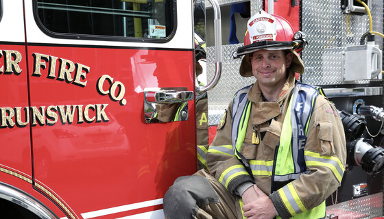 Fireman in front of a firetruck