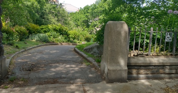 Park entrance ramp with ADA signage.