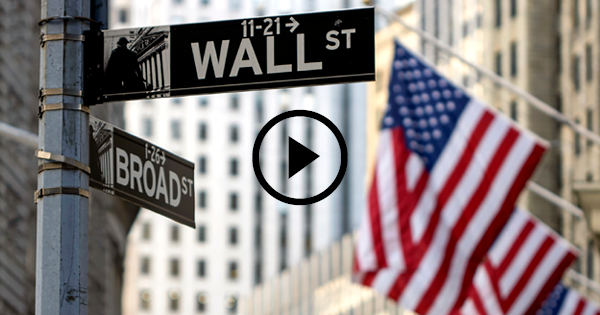 American flag by Wall Street sign.