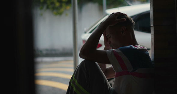 Man sitting with hands on the top of his head