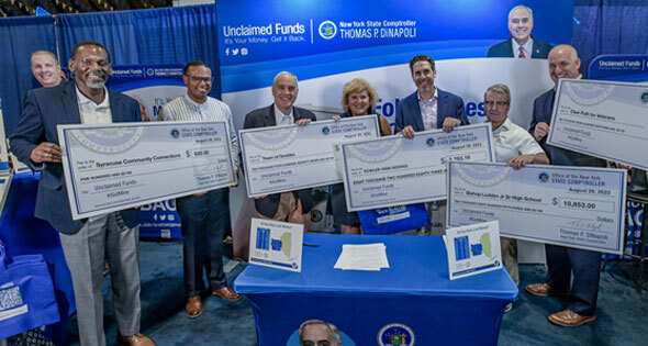 Comptroller DiNapoli awarding big checks.