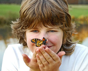 woman holding a monarch butterfly