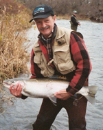 DEC Chief of Fisheries Phil Hulbert holding a large steelhead