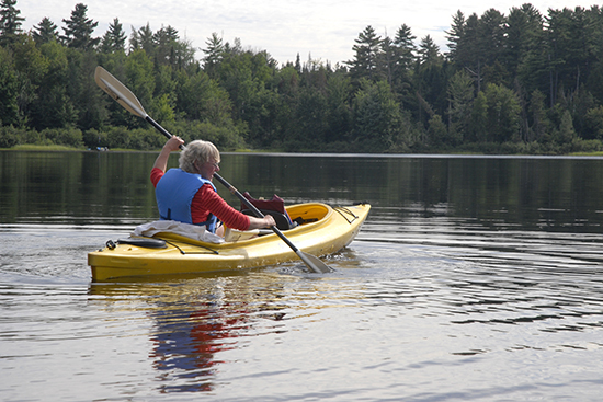 woman paddling in a kayak at Gilbert Lake