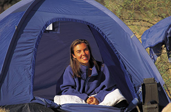 A woman sitting in her tent.
