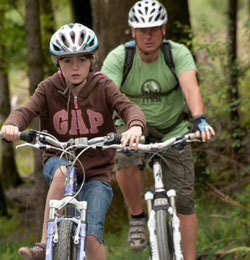 A father and daughter mountain biking
