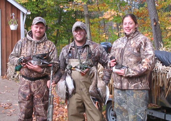Hunters holding waterfowl