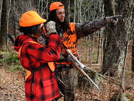 Hunters in the woods wearing hunter orange