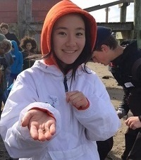 Young girl holding juvenile blue crab
