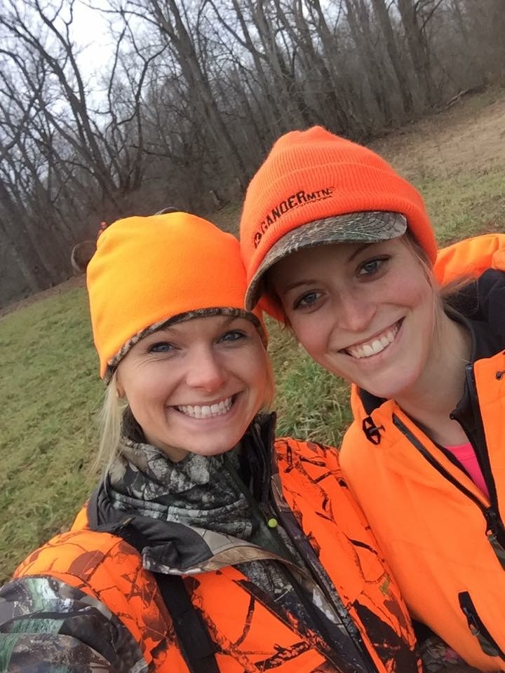 Two woman wearing blaze orange