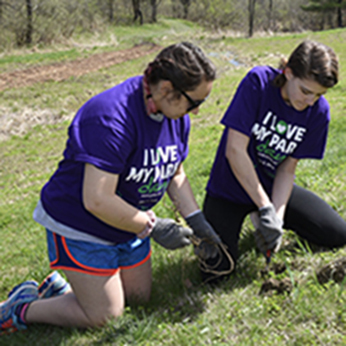 Two girls removing weeds at a 2018 I Love My Park Day Event