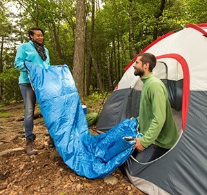 Young couple setting up a tent to camp out