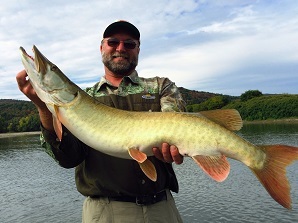 man holding a muskie