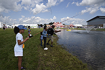 A group of children fishing at the pond at the NYS experience