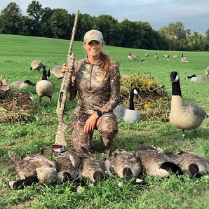 woman with harvested geese and goose decoys