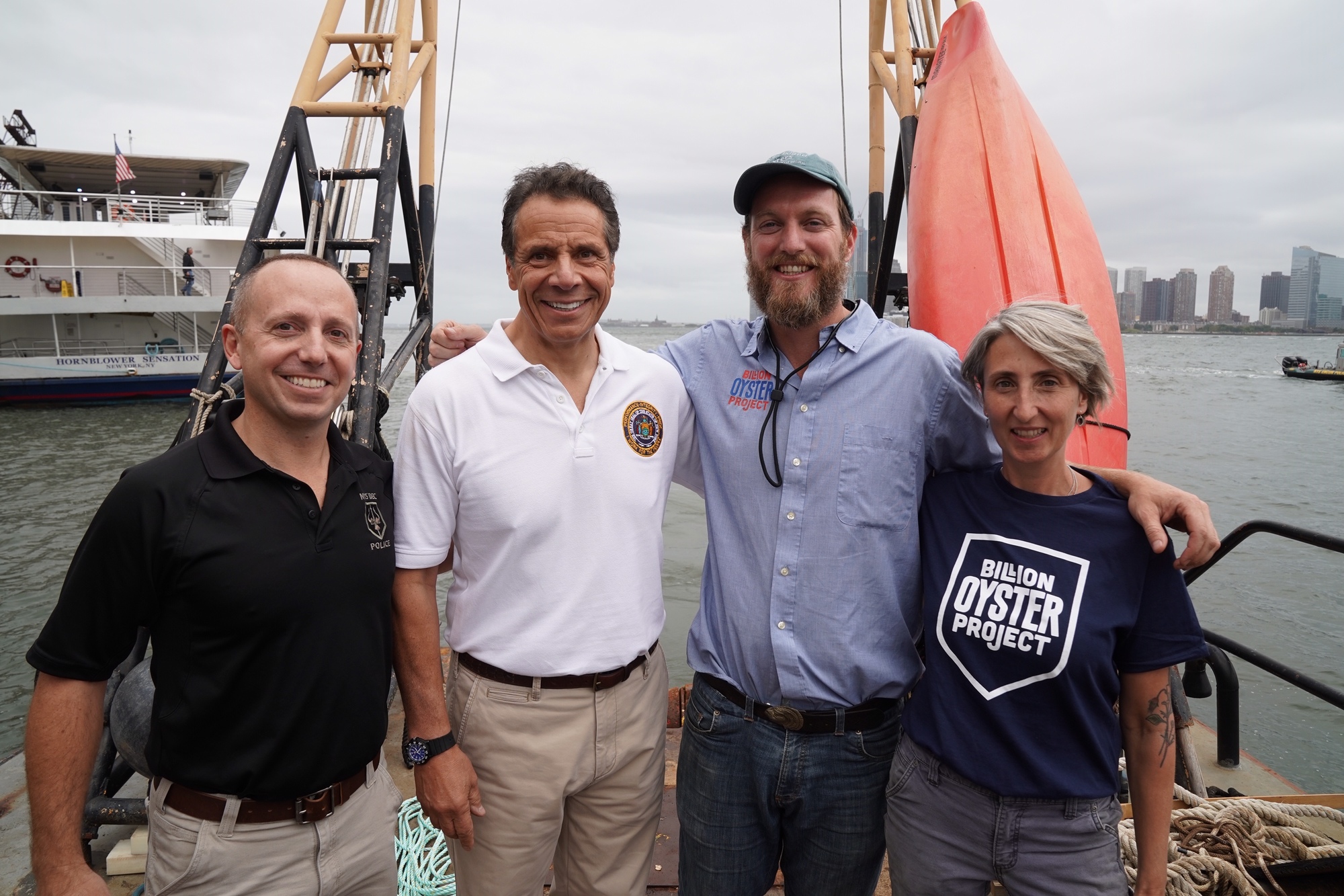 Governor Cuomo and partners at event to release thousands of shellfish in NYC waterways. 