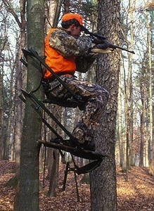 Hunter in a treestand wearing hunter orange