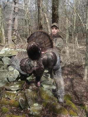 Hunter holding up a turkey