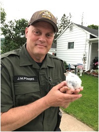 ECO Powers holding bird he rescued