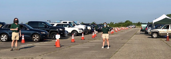 Staff in parking lot with orange cones set up