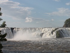 A large waterfall with rushing water.