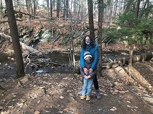 Adult and child hikers wearing masks