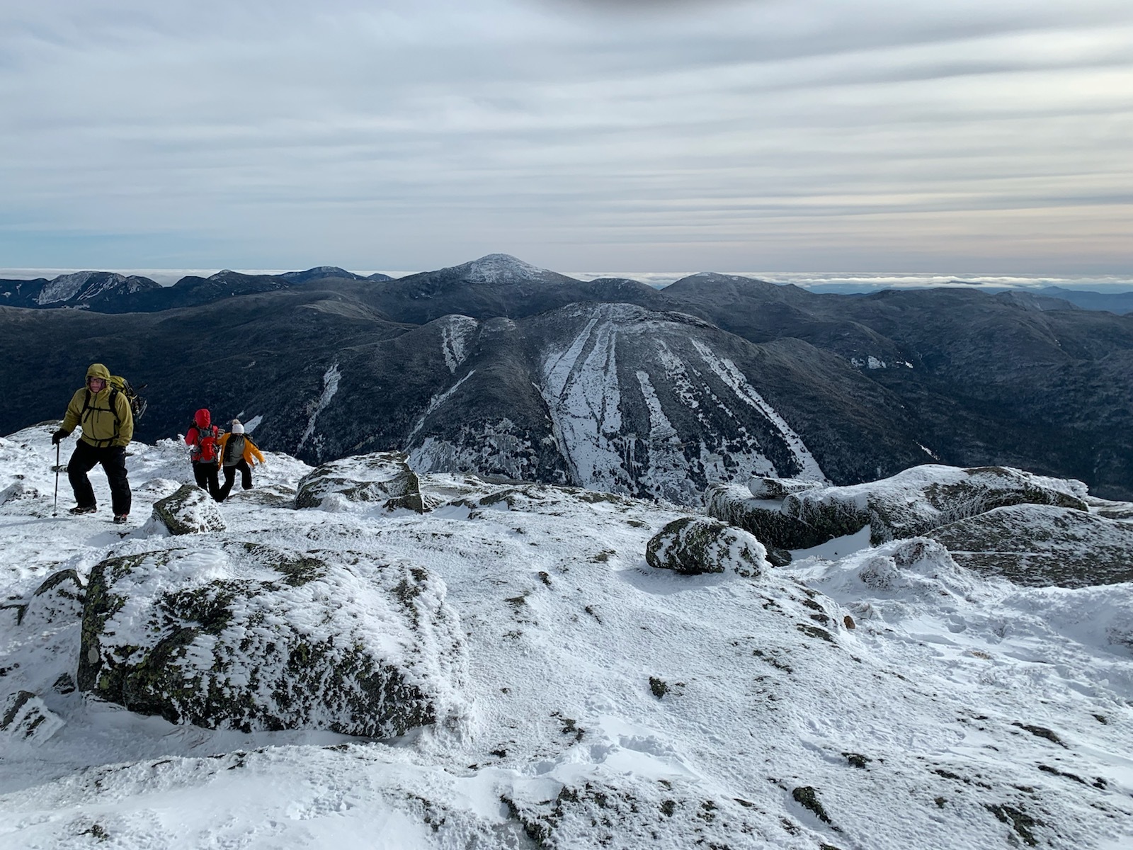 Hikers on Snowy Summit