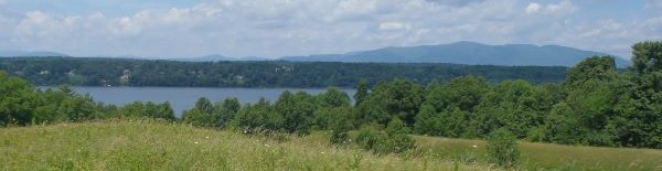 Image of the Hudson River in summer with hills in the background.