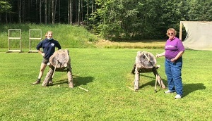 Mom and daughter learning tomahawk throwing at GS camp