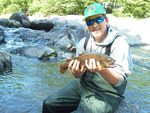 Young angler with brown trout