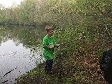 child picking up litter