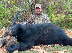 Eli McCaig with a female bear he harvested in Steuben County