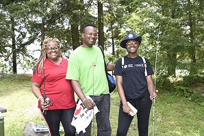 3 people holding fishing poles