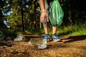 person picking up trash