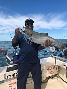 Angler with Chinook salmon