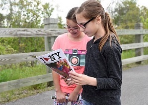 2 girls reading I Bird NY magazine