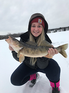 Ice angler with walleye