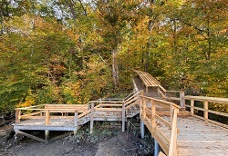 yellow, orange, and green trees in the background showing the new accessible viewing platform and boat launch at tivoli bay