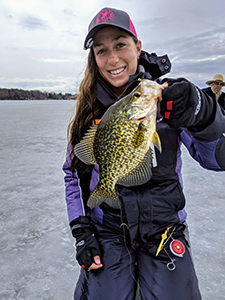 Ice angler with a black crappie