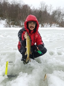 Angler holding up Chain Pickerel