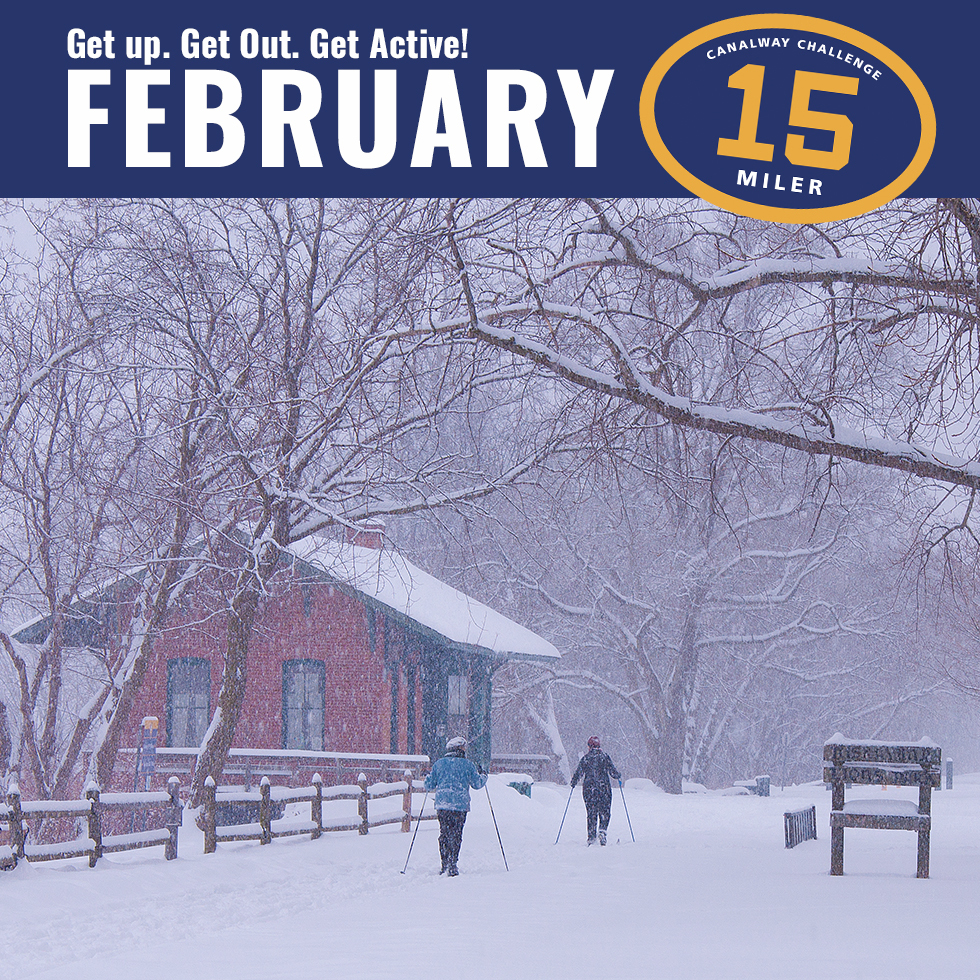 two individuals cross country skiing along the canalway trail